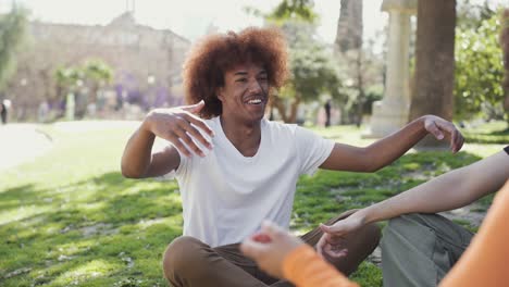 cheerful multiethnic friends laughing in park