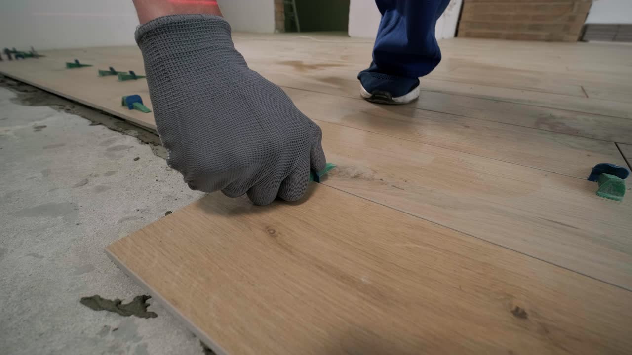 Installing ceramic floor tiles - measuring and cutting the pieces. Construction, renovation, repair apartment. Cuts tile. Tile cutting