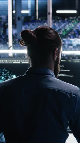 vertical video data center computer scientist using pc to monitor neural network using ai llm