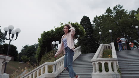 woman running up the stairs in a park