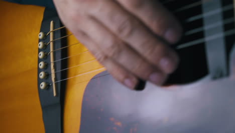 el guitarrista conecta el jack a la salida de plata de la guitarra acústica