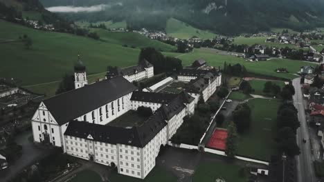 drone aerial over large courtyard and showing the whole town of endelberg abbey in switzerland