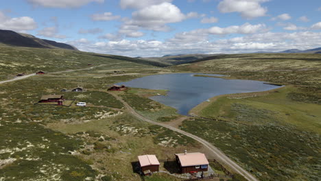 Aerial-shot-of-valley-and-houses-in-the-green-grasses