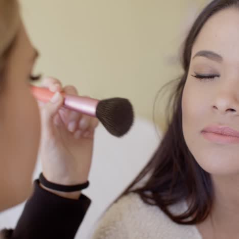 female cosmetician working with client