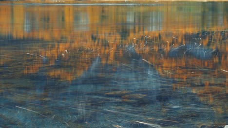 A-mix-of-foam-and-bubbles-floats-on-the-water-surface-leaving-trails-as-it-moves-with-the-current