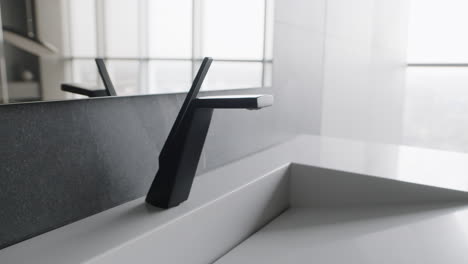 modern black faucet in a contemporary bathroom