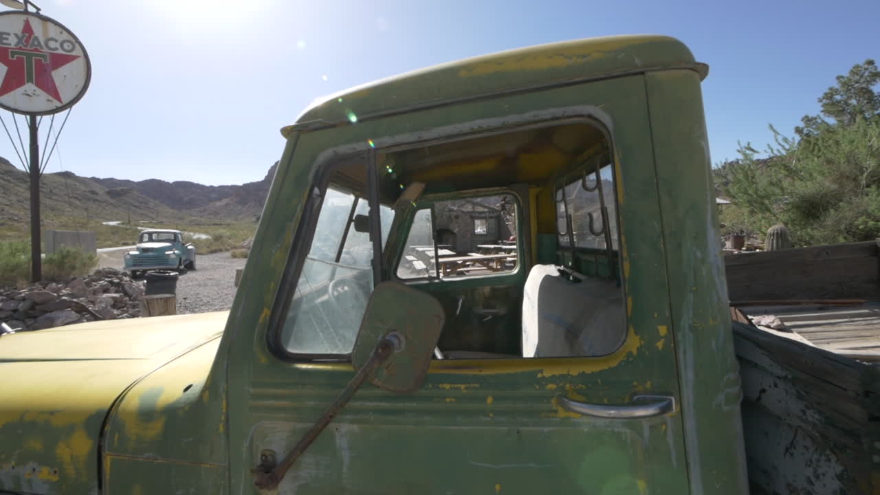 Slow pull trough of an abandoned weathered green pickup truck cab, Eldorado Canyon Nelson, Nevada