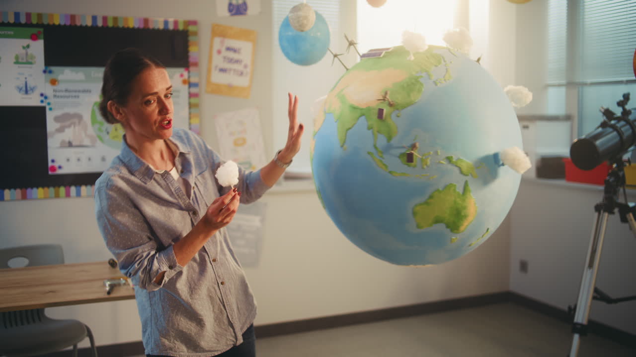 Ecology STEM Class Elementary School Boy Attaching Miniature Model of Wind Turbine to Globe