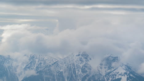 Time-Lapse-of-Clouds-Rising-Above-Snow-Capped-Peaks-of-Austrian-Alps