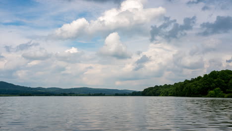 a time-lapse of a beautiful lake in the wilderness with a sky full of puffy clouds