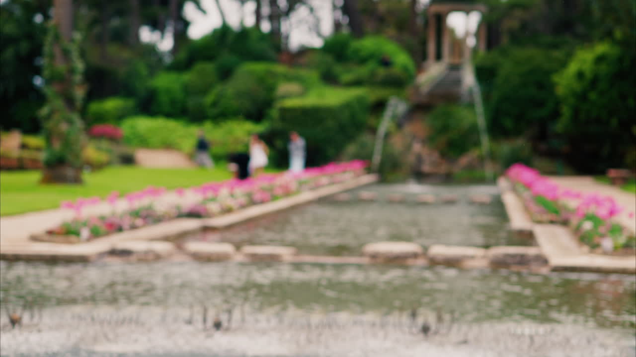 Close up of a water fountain in the courtyard of Villa Ephrussi de Rothschild with a blurred view on the background