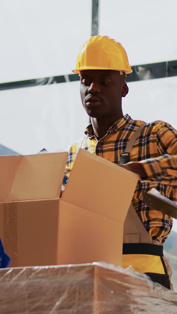 Vertical video: Team of workers preparing packages for stock transport