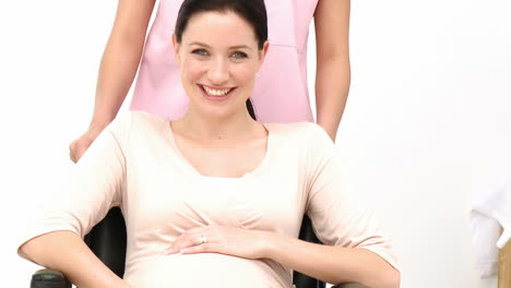 portrait of pregnant woman sitting on wheelchair