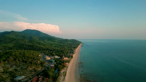 4K-Cinematic-nature-drone-footage-of-a-panoramic-aerial-view-of-the-beautiful-beaches-and-mountains-on-the-island-of-Koh-Lanta-in-Krabi,-South-Thailand,-during-sunset