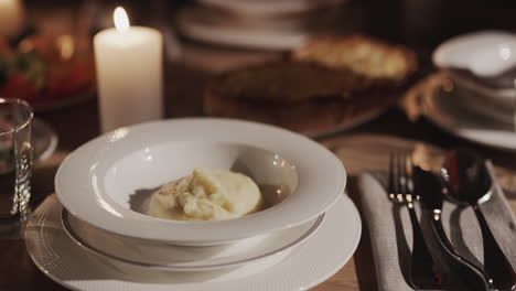 the soup is placed on a plate. festively served table