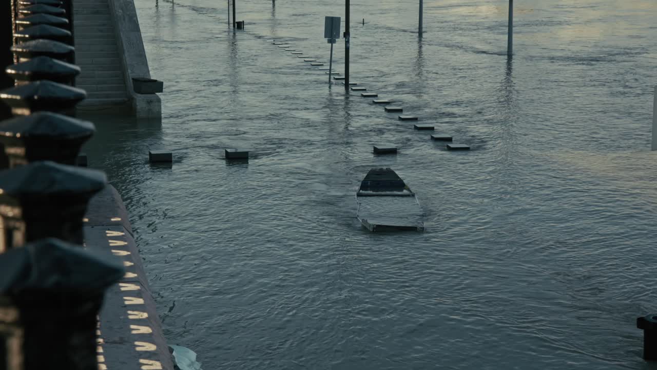 Submerged street and benches underwater during the Budapest Flood 2024 along the Danube River in front of the parliament building