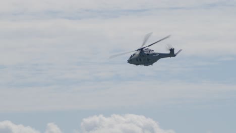 slowmotion tracking shot of a navy helicopter cornering at full speed