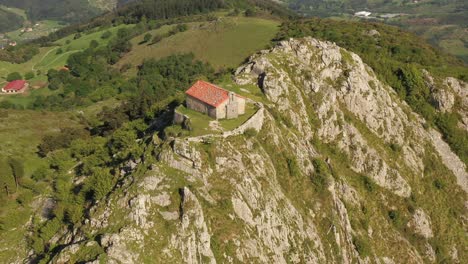 aerial drone view of the hermitage of santa eufemia on the top of a mountain in aulestia in the basque country