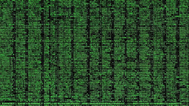 A video still showing a digital rain of green binary code on a black background