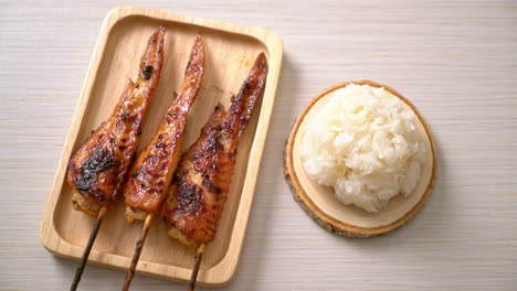 grilled or barbecue chicken wings skewer with sticky rice