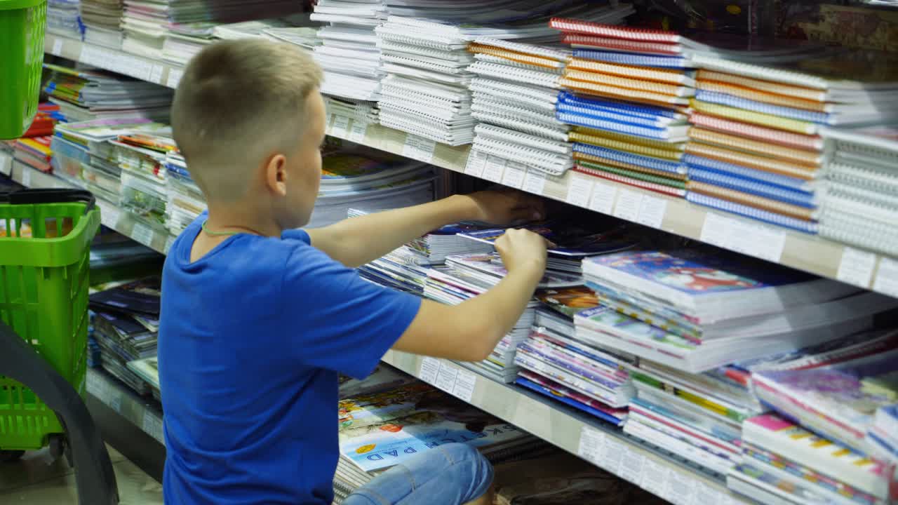 Vinnitsa, Ukraine - August, 2018: Boy choosing buying stationery in store preparing for first day in school.