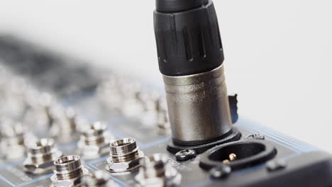 XLR cable attached to an audio mixer
