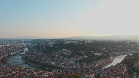 cinematic circling drone shot of lyon basilica and river rhone saone at sunset