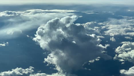 aerial view of a tiny cumulus cloud recorded from a jet cockpit, flying at 12000m high