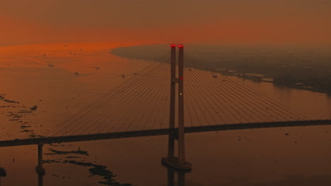 sunset view of a bridge over water in vietnam, peaceful and cinematic mood