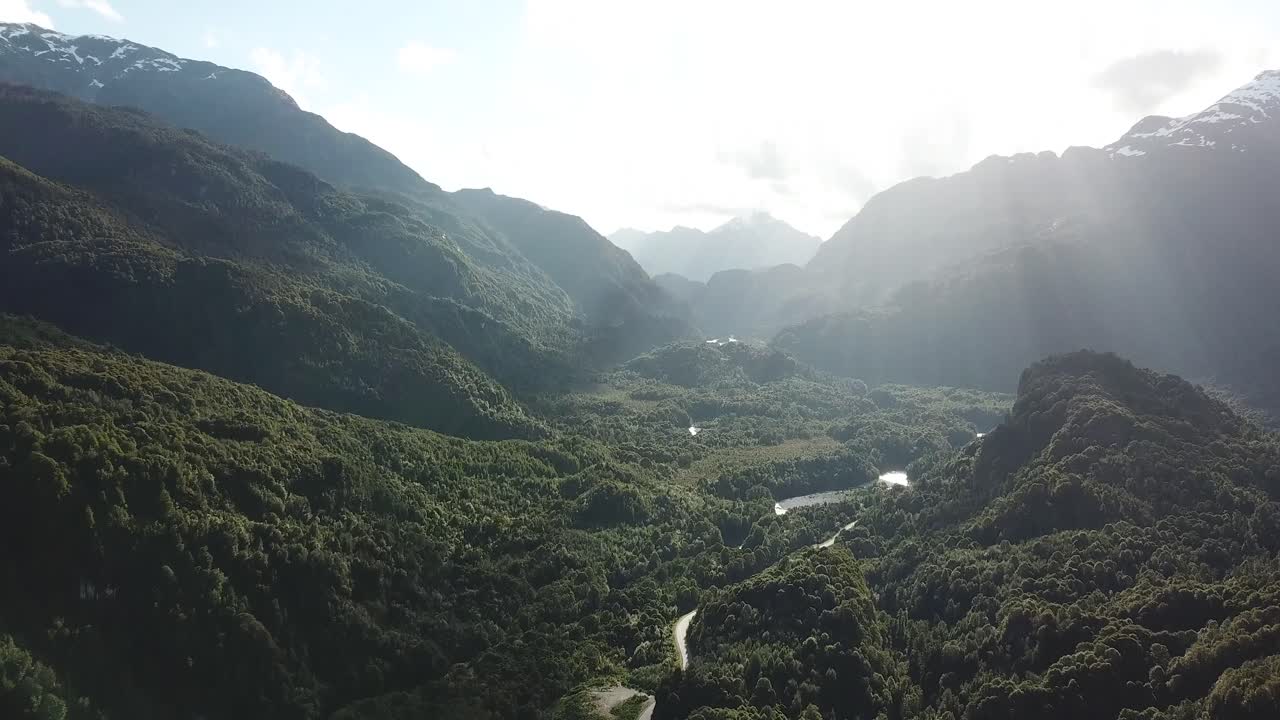 Picturesque Landscape of Chilean Andes. Road, River Canyon and Forest Hills Under Evening Sunlight Backlight