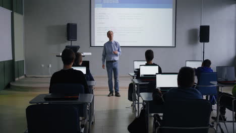 teacher leading a computer science class