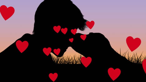 multiple red heart icons floating against silhouette of a boy and dog in the park