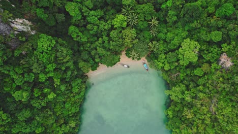 Aerial-Drone-Soars-Above-Long-Tail-Boat,-Revealing-Stunning-Turquoise-Waters-and-Limestone-Cliffs-at-Blue's-Hong,-Ko-Roi,-Thailand