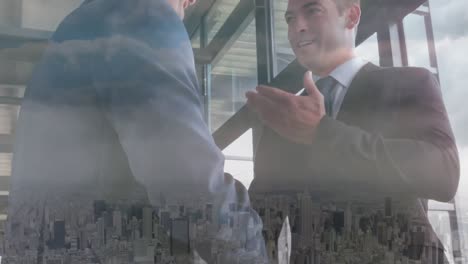 Animation-of-businessman-handshake-over-cityscape