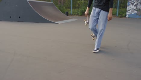 camera focuses on young man legs, skate shoes and skateboard