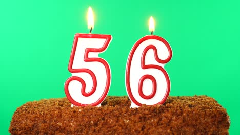 cake with the number 56 lighted candle. chroma key. green screen. isolated