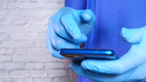 person using a smartphone while wearing gloves