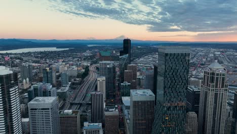 drone shot of downtown skyscrapers in the evening glow in seattle, washington