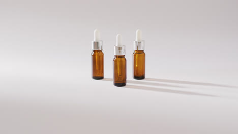 close up of dropper serum bottles on white background with copy space