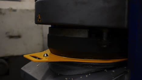 transforming huge pile of dough into small balls by industrial hot cutter shaping machine inside bread factory