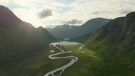 scenic jotunheim valley with river snaking through, dramatic landscape