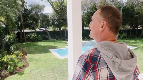 mature man looking at view from balcony 4k