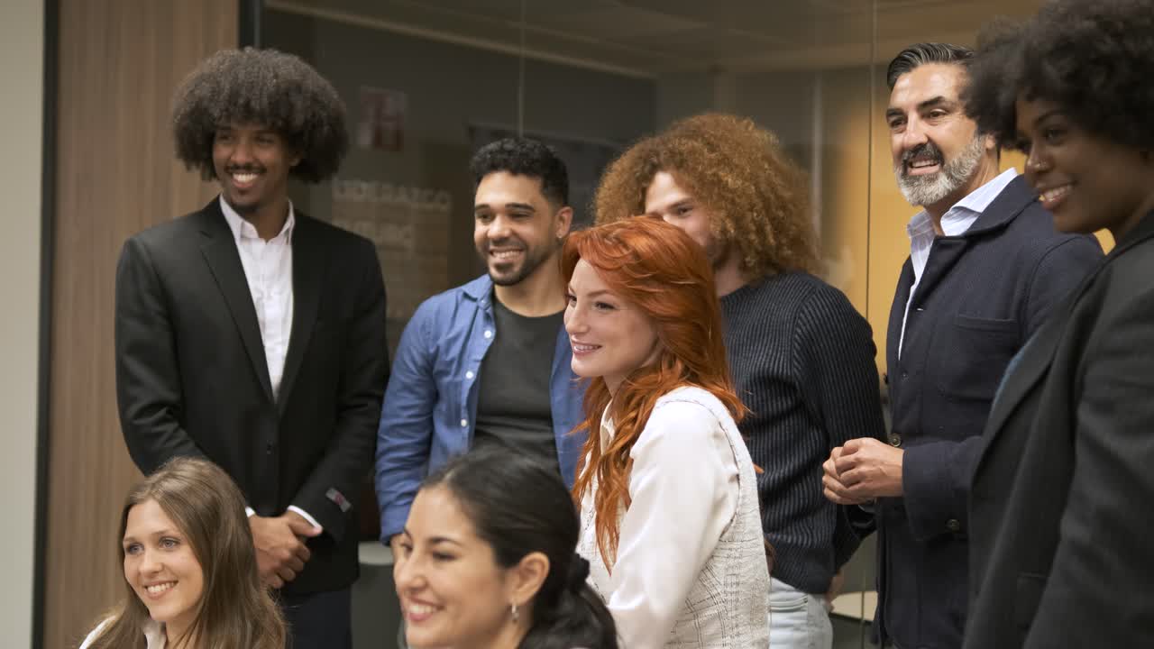 Contented multiethnic businesspeople posing in creative office