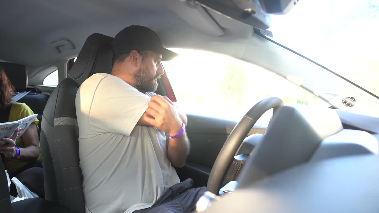 Man putting on his seatbelt in the car