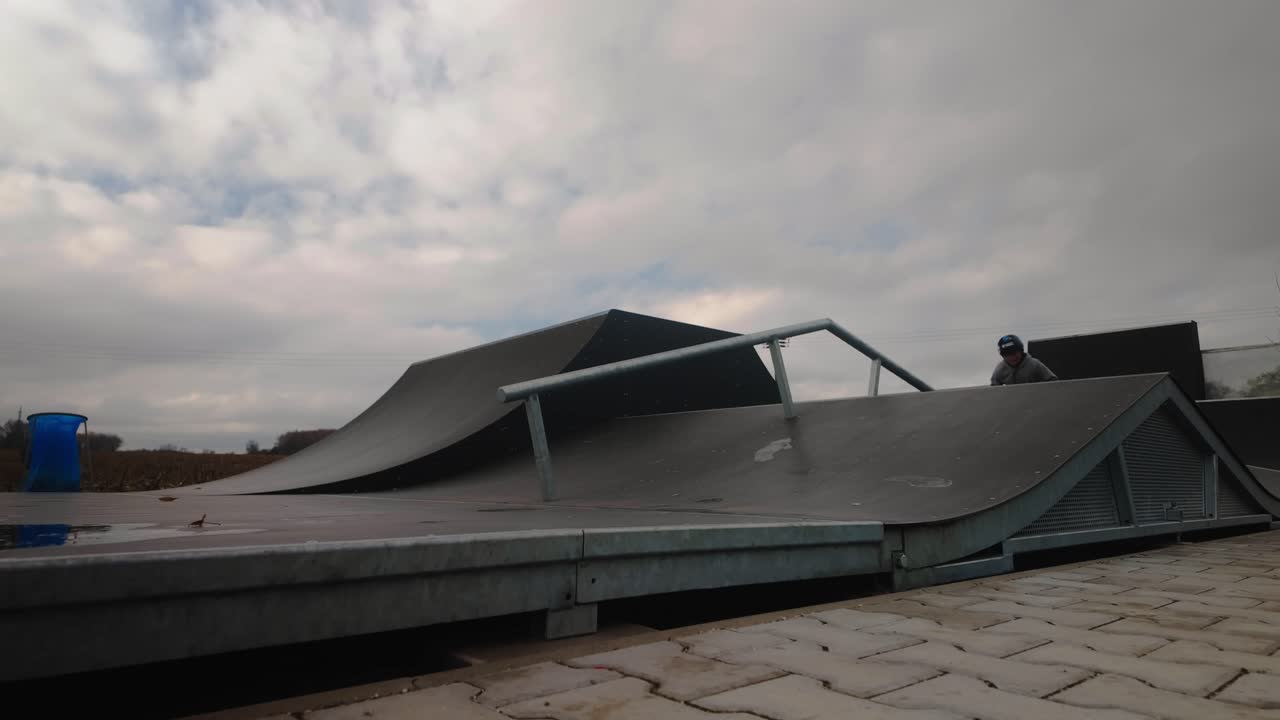 Young scooter skater practices ramp jump trick technique Slow-mo action