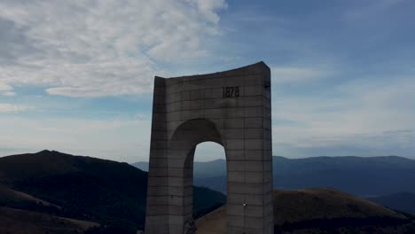 iconic arch of freedom monument on hilltop, beklemeto pass, bulgaria