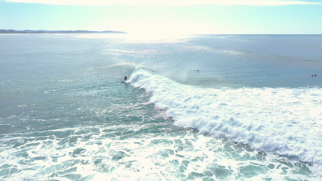 4k Aerial wide shot of a surfer surfing on a ocean sea wave in Australia.