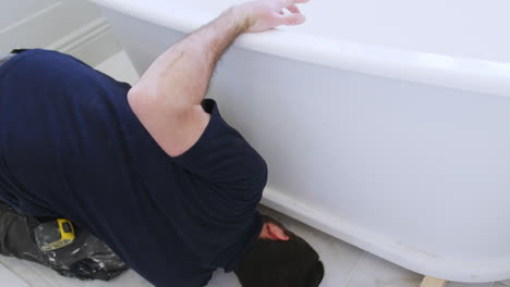 Plumber-In-Bathroom-Fitting-New-Free-Standing-Bath