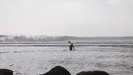 Surfers-trying-out-wild-waves-at-Bali-indonesia-Asia