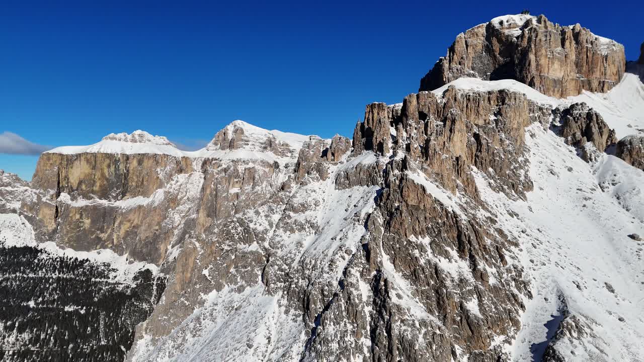 Huge rock formation in the Italian Dolomites shot during winter season (drone footage)